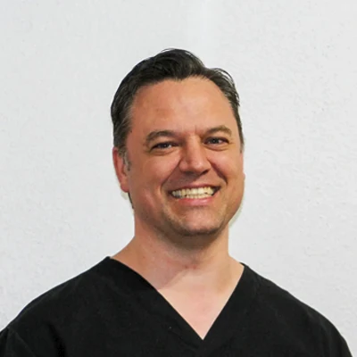 A headshot of Dr. Trevis Rawlinson, a chiropractor at Rawlinson Chiropractic.